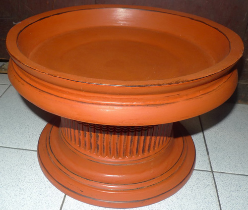 Monk offering plate